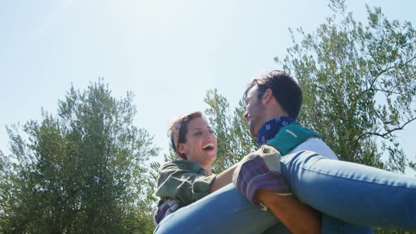 Man carrying woman in olive farm 4k