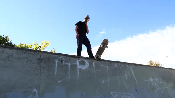 A young skateboarder skating in the bowl of a skate park.