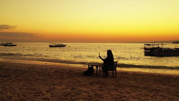 Lady alone relaxing on exotic resort beach holiday by blue sea and bright sand background of the Mal