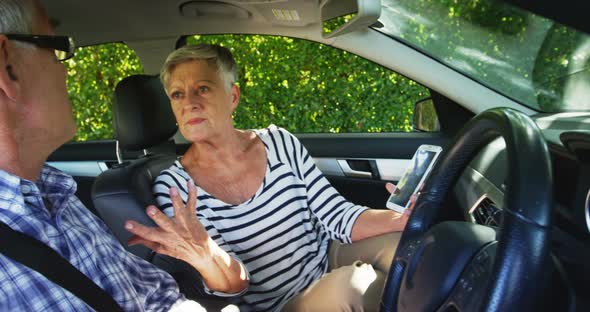 Senior couple arguing in the car