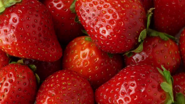 Juicy ripe exotic strawberry rotates on a white background 360. Eco fruits and berries summer.