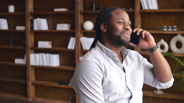 Young African American Male Employee Has Phone Conversation