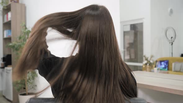 Demonstration of the Brunette's Hair Before Straightening It