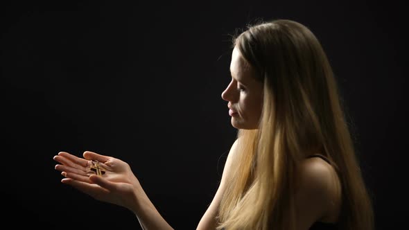 Blonde Woman Praying to God, Holding Cross in Hands, Faith and Spirituality