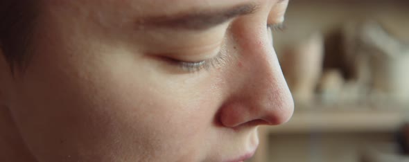 Female Artist Sculpting Head Out of Clay