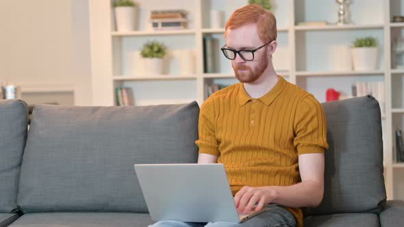 Redhead Man Finishing Laptop Work and Going Away 