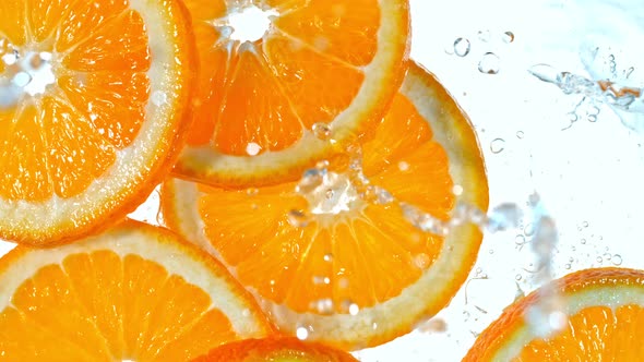 Super Slow Motion Shot of Splashing Orange Slices at 1000Fps