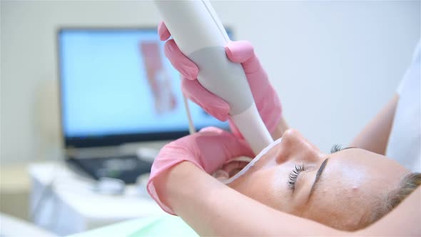 Dentist With Dental Intraoral Scanner Scanning Patient's Teeth.