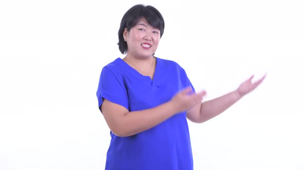 Happy Overweight Asian Businesswoman Presenting Something