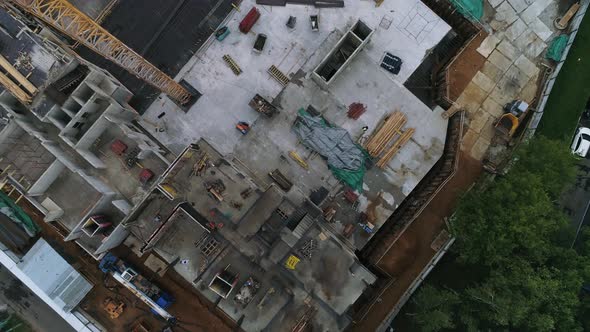 Aerial view from the copter on unfinished buildng among the city