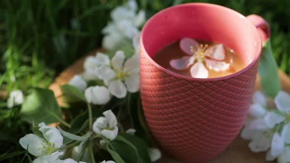 White Flower Falls Into a Cup of Coffee