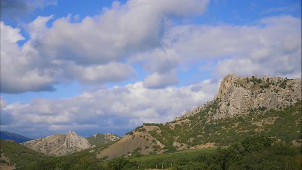 Mountains Against the Blue Sky with White Clouds. Sirus Clouds Run Across the Blue Sky