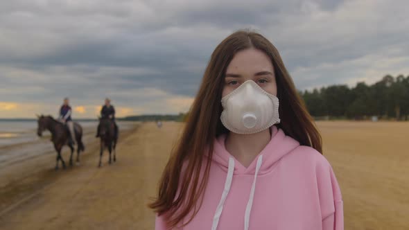 The Girl in the Mask Isolated on the Beach