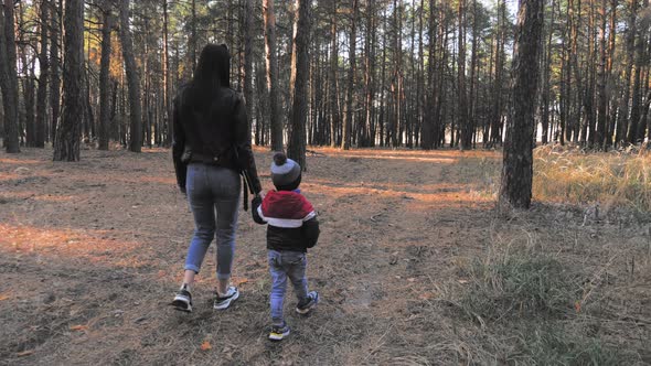 Cute Little Boy and Mother During the Walk in Nature