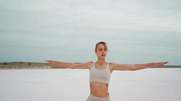 Steadycam Camera Moving Around Yoga Woman Practices at Beach Working Out and Relaxing Outside on