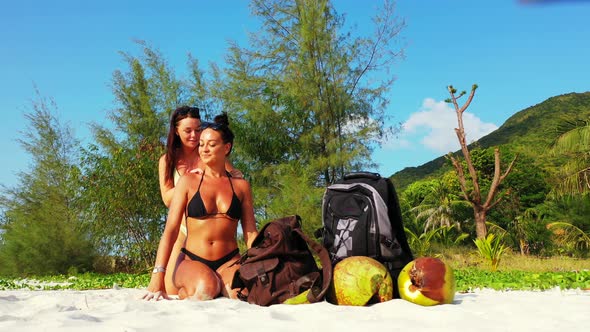 Sexy beauty models on holiday having fun at the beach on clean white sand and blue background 4K