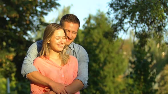 Man and Woman in Love Admiring Beautiful Sunset Tenderly Embracing, Magic Hour