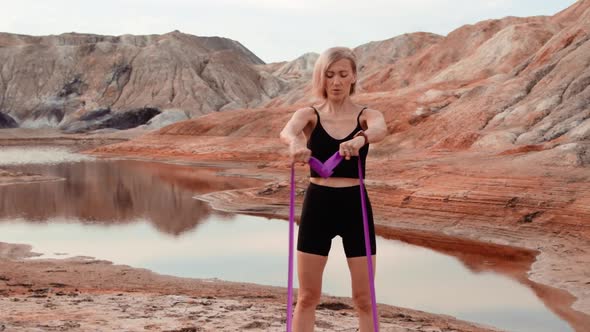 Woman working out on lifeless dried locality