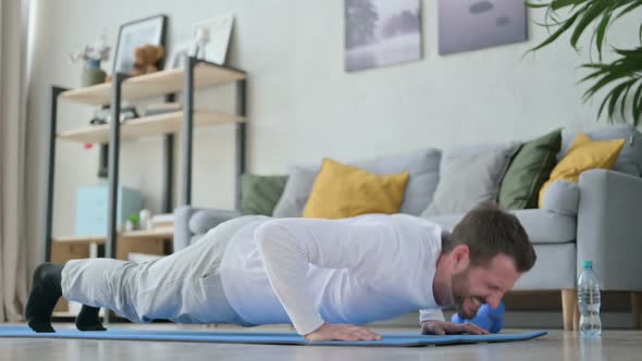Tired Man Doing Pushups on Yoga Mat at Home