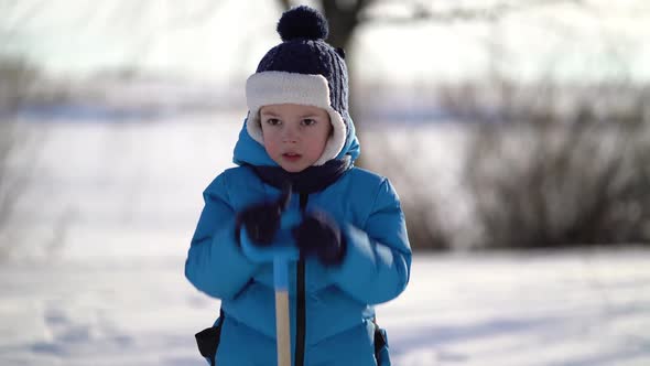 Little Boy Shoveling Snow at Winter