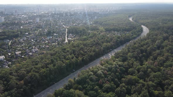 Megalopolis Next To the Forest: the Contact Between the Big City and Nature. Aerial View. Slow