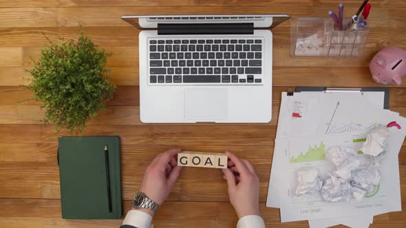 Word goal is made of wooden cubes on the office table. Concept of achieving the goal and purpose.