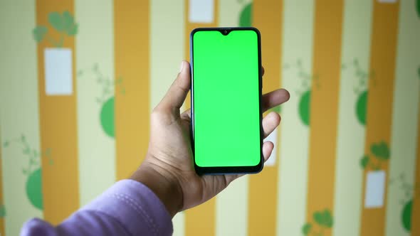 Close Up of Young Man Hand Using Smart Phone with Green Screen