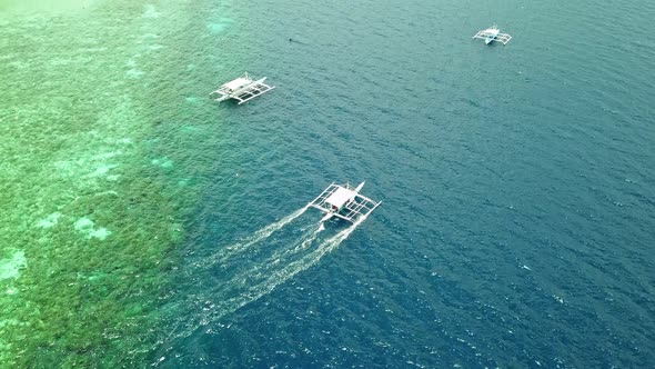 Outrigger Boat Sails On Calm Blue Waters Of Tanon Strait In Moalboal Cebu Philippines