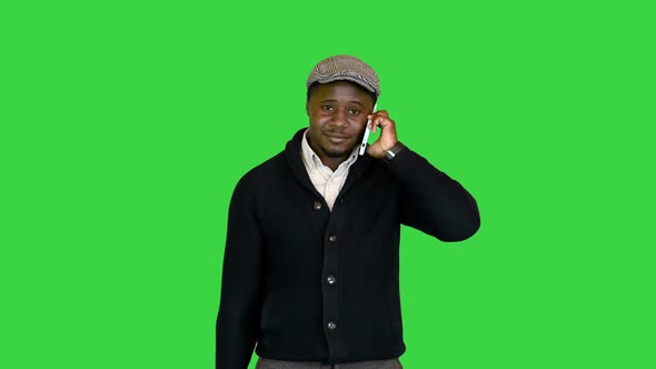 Handsome Black Guy with a Bag Talking on the Phone on a Green Screen Chroma Key