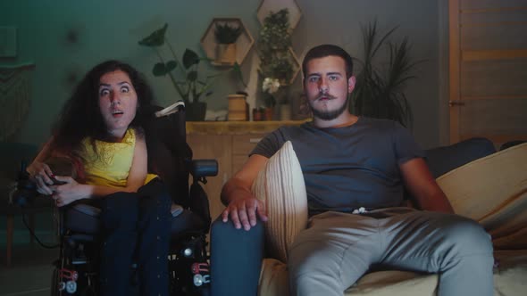 Surprised Couple Watching Movie at Home