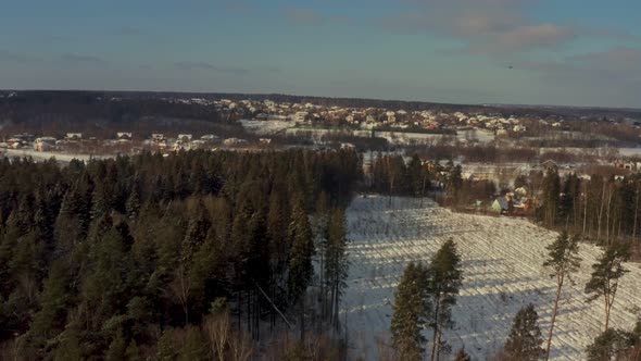 View of the Village in Winter From the Green Forest