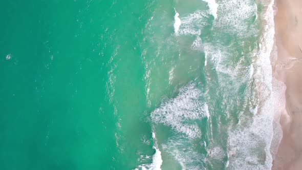 Top view tropical beach Amazing waves sea background. Crashing waves on beach sand, Beautiful sea