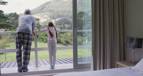 Girl with father looking out of the balcony 4k