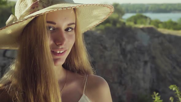 Girl on a Background of a Beautiful Landscape Smiling. Slow Motion. Close Up