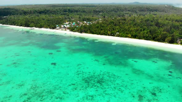 Aerial: flying over tropical beach island coral reef turquoise caribbean sea