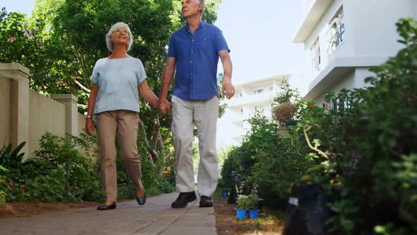 Senior couple walking in the garden