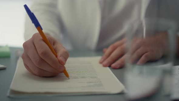 Doctor Hands Writing Medical Documents Close Up