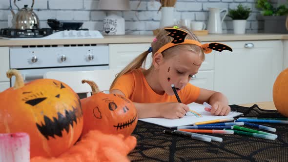 Little Girl Drawing with Felt-Pens in Halloween