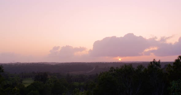 The Sun Sets Over the Horizon. Beautiful Sunset and Amazing Colorful Clouds. Timelapse