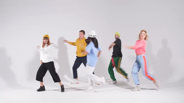 Active Cheerful Dancers Posing Over Pink Background After Concert