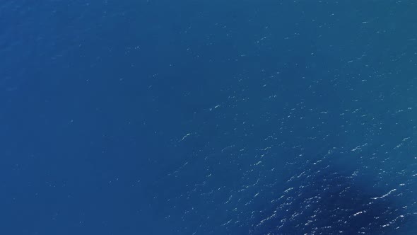 Aerial View of the Blue Sea Sparkling From the Sun and Yachts with Tourists on the Deck