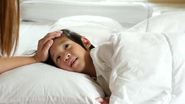 Cute Asian Child Sleeping On White Bed With Mother Care