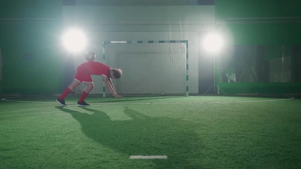 Professional Football Player Performs a Tricks with a Soccer Ball Balances the Ball on Legs Slow