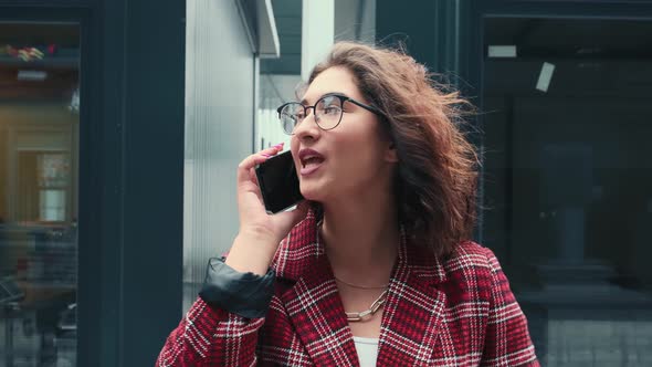 A Young Girl is Talking on the Phone