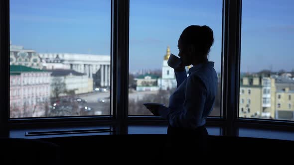 Confident Woman Drinking Tea By Hotel Window