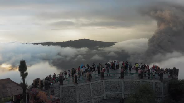 Drone Aerial View of Active Volcano Bromo. Sunrise, Crowd of Tourists on the Viewpoint.  Short.