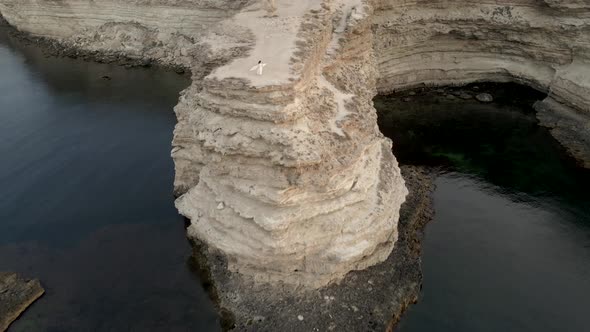 Arch Shape Grotto in Ocean in Ocean Island, Bride After Wedding in Honeymoon