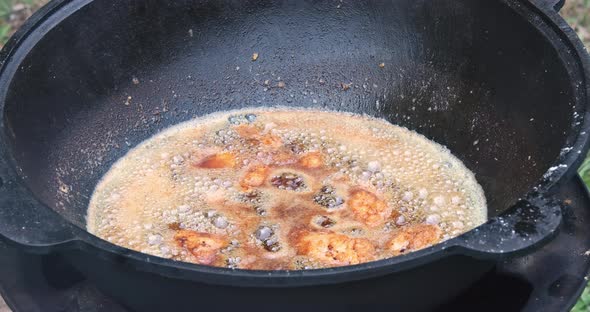 Delicious Frying Chicken Wings Boiling Oil in a Cauldron