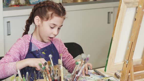 Little Happy Beautiful Girl Smiling To the Camera at the Art Studio