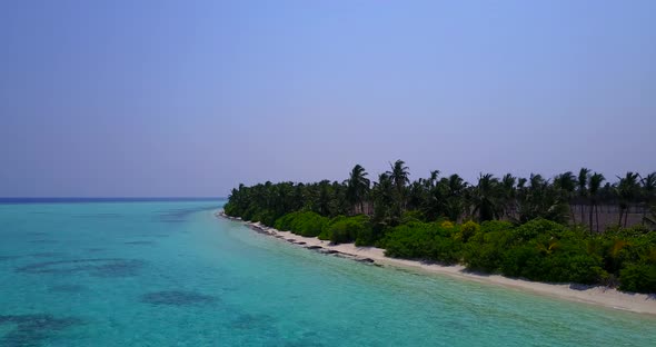 Natural flying abstract shot of a sandy white paradise beach and aqua blue water background in color